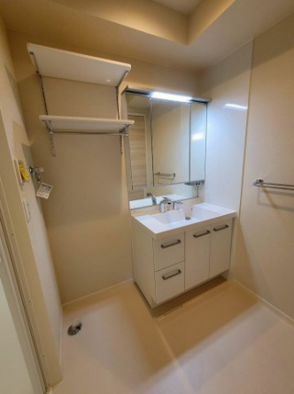 三面鏡のシャワー付き洗面台。戸建てでも使用する大き目の洗面台です！洗濯機置き場には可動式の棚もあって便利ですよ♪