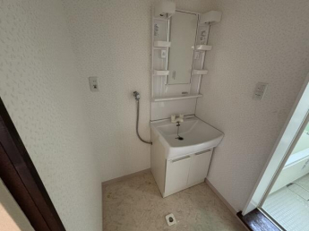 洗面所。洗面台と洗濯機置き場。